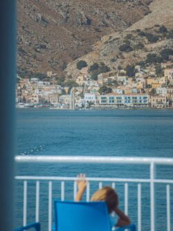 Relaxing seaside view of Rhodes, Greece with a distant village across the water.